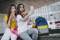 Two female friends making selfie with hot dogs