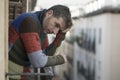 Urban lifestyle emotional portrait of 30s handsome man sad and depressed at home balcony leaning upset feeling desperate suffering Royalty Free Stock Photo