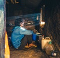 Urban man seeks solace in the Himalayan rustic mud house, pondering life as sun rays grace his face Royalty Free Stock Photo