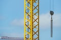 urban metal cranes for the construction of buildings with a hook with chains and a turret with a ladder