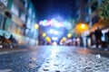 Urban night scene with people walking out of focus with colored background