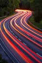 Urban night traffic blurred cars on illuminated highway with long exposure light trails