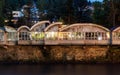 Urban night views and decoration of the city Chiatura , Georgia. Blue sky with clouds. River and old houses Royalty Free Stock Photo