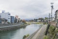 Urban or park background featuring Saigawa river and bridges across in residential district of Kanazawa