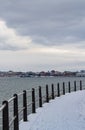Urban pathway promenade with snow by the sea in winter cold day