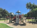 Urban playground at public park surrounded by large trees in downtown Dallas, Texas, USA Royalty Free Stock Photo