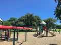 Urban playground at public park surrounded by large trees in downtown Dallas, Texas, USA Royalty Free Stock Photo