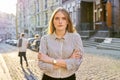 Urban portrait of beautiful young blonde woman on city street at sunset Royalty Free Stock Photo