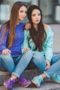 Urban portrait of two beautiful girlfriends. Royalty Free Stock Photo