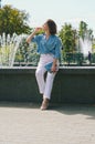 Urban portrait of young elegant business woman in eye glasses and casual clothes in city. Woman walking in green park, relaxing Royalty Free Stock Photo