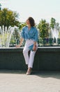 Urban portrait of young elegant business woman in eye glasses and casual clothes in city. Woman walking in green park, relaxing Royalty Free Stock Photo