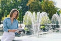 Urban portrait of young elegant business woman in eye glasses and casual clothes in city. Woman walking in green park, relaxing Royalty Free Stock Photo