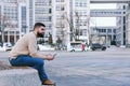 Urban portrait of young happy elegant business man in winter casual clothes, jeans, sweater. Walking in street, talking on phone Royalty Free Stock Photo