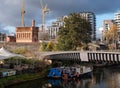 Urban regeneration of Kings Cross London UK, with new build flats and historic red brick Victorian water tower at left. Royalty Free Stock Photo