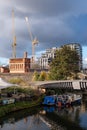 Urban regeneration of Kings Cross London UK, with new build flats and historic red brick Victorian water tower at left. Royalty Free Stock Photo