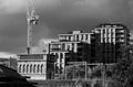 Urban regeneration of Kings Cross London UK, with new build flats and historic red brick Victorian water tower at left. Royalty Free Stock Photo