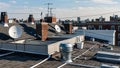 Urban rooftops with satellite dishes, duct systems, and laundry lines in rows Royalty Free Stock Photo