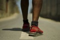 Urban runner workout . Back view in detail of athletic black African American sport man legs and feet in running shoes training Royalty Free Stock Photo