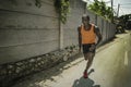 Urban runner workout . Young attractive and athletic black African American man running outdoors on asphalt road training hard Royalty Free Stock Photo