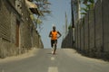 Urban runner workout . Young attractive and athletic black African American man running outdoors on asphalt road training hard Royalty Free Stock Photo