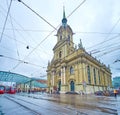 Urban scene on Bubenbergplatz with tram station under modern glass canopy and historic Heiliggeistkirche in Bern, Switzerland