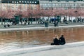 urban scene with city river, buildings, blooming trees and citizens in Stockholm, Sweden Royalty Free Stock Photo