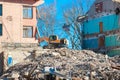 Urban scene. Dismantling of a house. Building demolition and crashing by machinery for new construction. Industry Royalty Free Stock Photo