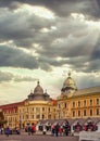 Urban scene featuring a bustling Cluj-Napoca city square, populated with a diverse crowd of people