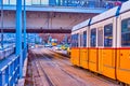 Urban scene on Jane Haining quay with yellow trams and cars, Budapest, Hungary