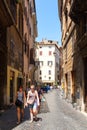 Urban scene at a narrow cobblestone street in Rome