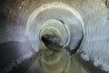 Urban sewage flowing throw round sewer tunnel pipe Royalty Free Stock Photo