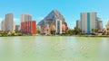 Urban skyline of Calpe, Penon de Ifach or Penyal de Ifac rock, salt lake with flying flock of flamingos birds