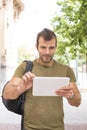 Urban smiling man laptop with tablet computer in the street. Royalty Free Stock Photo