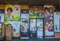 Urban store front with doors covered in various types of signs