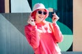 Urban street fashion. Vanilla Girl. Kawaii vibes. Candy colors design. Bucket hat trends. Young woman with pink hair and