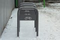 Urban street gray metal bike rack with white bike badge