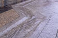 Street gutter with water flow on tiled sidewalk at rainy day. background, weather.