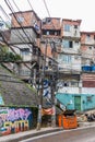 Urban view of street art and electricity cables and slum houses in the Rocinha favela in Rio de Janeiro, Brazil, South America