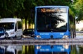 urban street scene after heavy storm. passenger bus driving through deep flood waterflooded road.