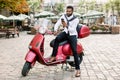 Urban style, city business. Young african american bearded guy, wearing smart casual clothes, using his mobile phone Royalty Free Stock Photo