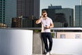 Urban style guy chatting on phone in Tampa city. Portrait of attractive man with casual clothes talking on phone in Royalty Free Stock Photo