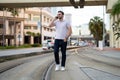 Urban style guy chatting on phone in Tampa city. Portrait of attractive man with casual clothes talking on phone in Royalty Free Stock Photo