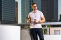 Urban style guy chatting on phone in Tampa city. Portrait of attractive man with casual clothes talking on phone in Royalty Free Stock Photo