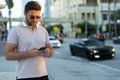 Urban style guy chatting on phone in Tampa city. Portrait of attractive man with casual clothes talking on phone in Royalty Free Stock Photo