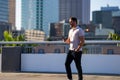 Urban style guy chatting on phone in Tampa city. Portrait of attractive man with casual clothes talking on phone in Royalty Free Stock Photo