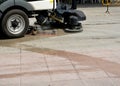 Urban sweeper cleans road from dirt with a round brush Royalty Free Stock Photo