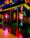 urban neon lights reflecting in the rain