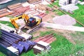 Urban tractor equipment for digging. The pipes are ready for laying in the ground. The excavator is ready to dig a trench. Working Royalty Free Stock Photo