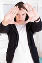 Urban trendy guy wearing hood framing his face with hands Royalty Free Stock Photo