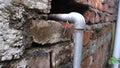 Urban Utility: Exposed GI Pipe Plumbing Fitting on Brick Wall, Dehradun City, India - Stock Media for Industrial and Architectural